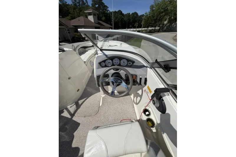 Slide: The Image of 2012 Stingray 235 LR boat cockpit with steering wheel and dashboard controls. - 5