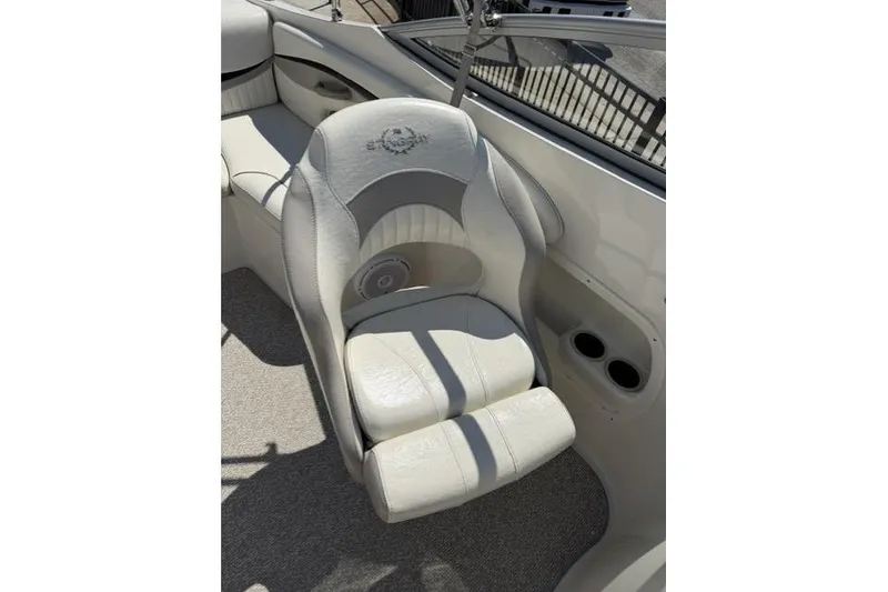 Slide: The Image of 2012 Stingray 235 LR boat interior with plush seating and cup holders. - 7