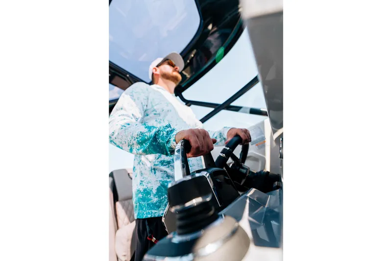 Slide: The Image of Man steering 2026 Navan S30 boat in sunny weather. - 15