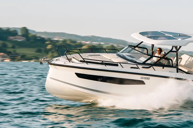 Slide: The Image of Navan S30 2026 motorboat cruising on a lake in sunny weather. - 26