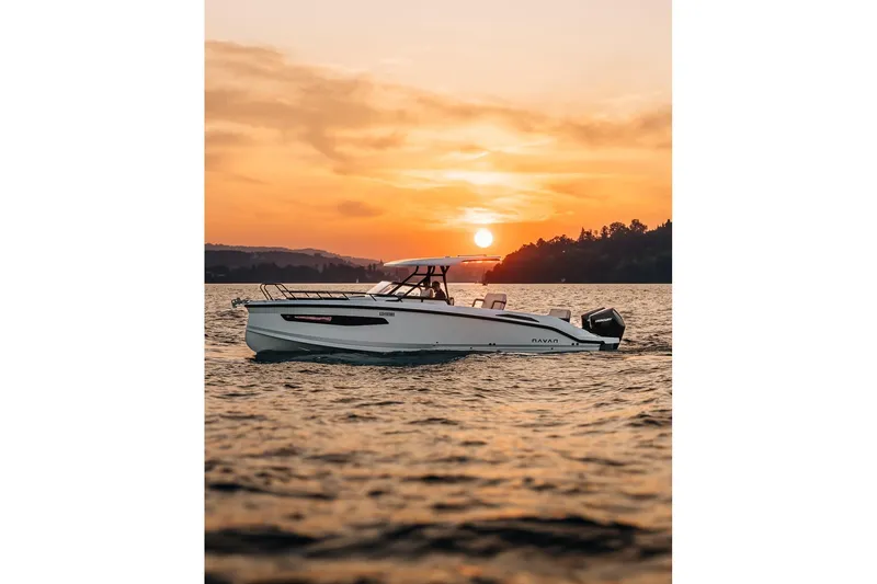 Slide: The Image of Navan S30 boat 2026 on water at sunset. - 28