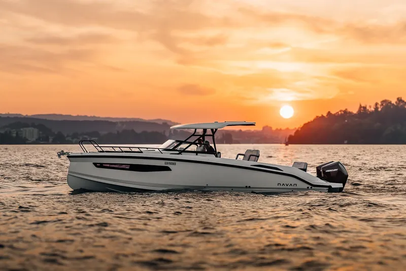 Slide: The Image of Navan S30 boat 2026 cruising at sunset on the water. - 29