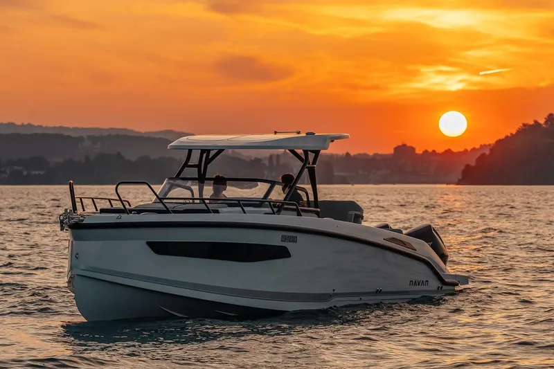 Slide: The Image of Navan S30 boat at sunset on the water, 2026 model. - 30