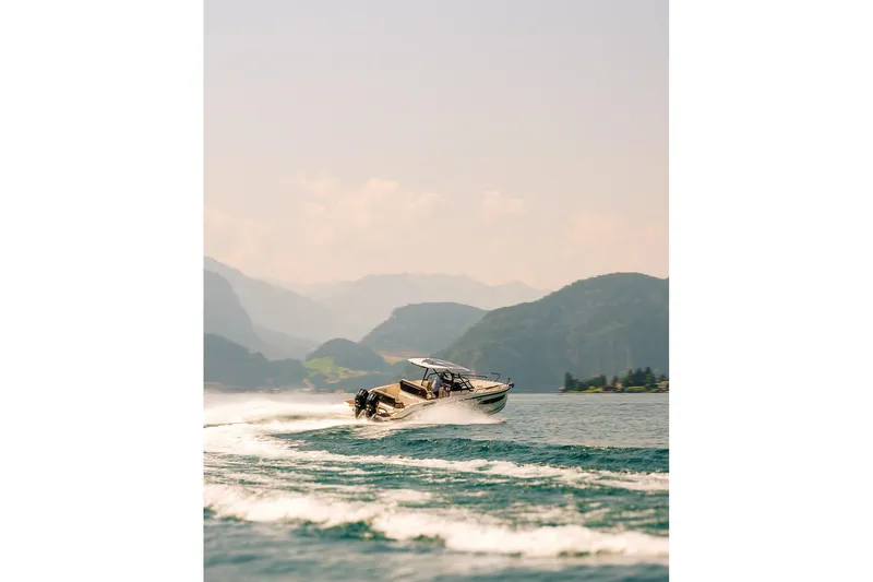 Slide: The Image of Navan S30 boat 2026 cruising on a lake with mountain backdrop. - 9