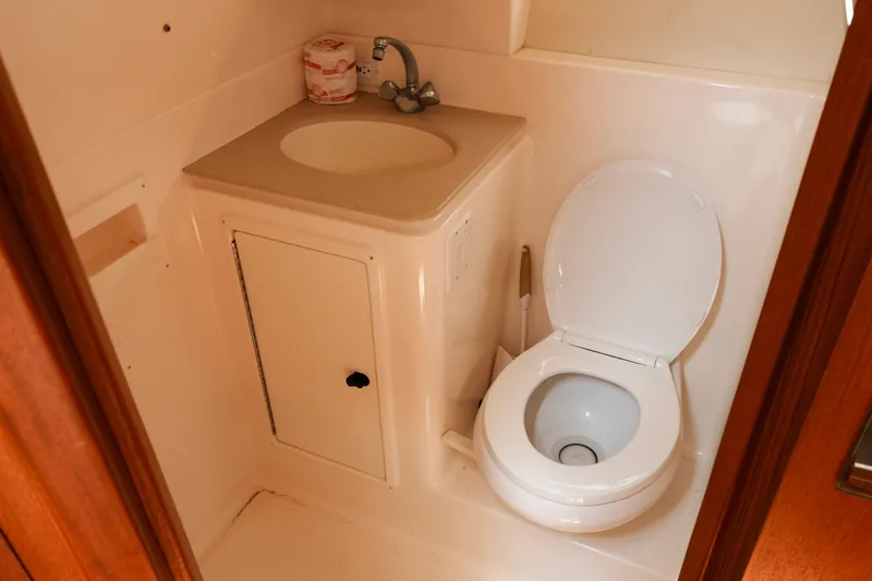 Slide: The Image of 1999 Tiara Yachts 3500 Open bathroom with sink and toilet. - 10
