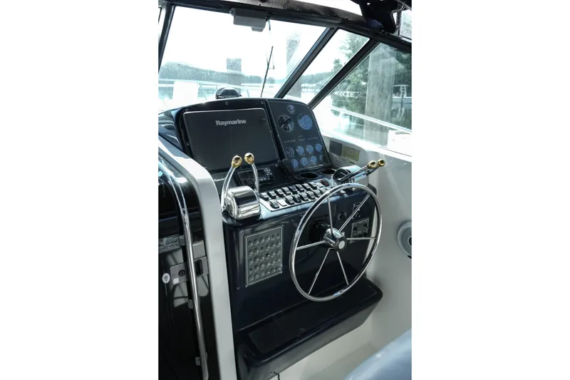 Slide: The Image of 1999 Tiara Yachts 3500 Open deck with Yeti cooler, docked by wooden pier. - 5