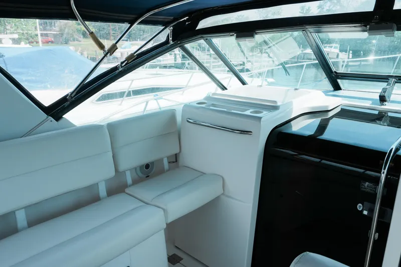 Slide: The Image of Interior of 1999 Tiara Yachts 3500 Open, featuring white seating and sleek design. - 9