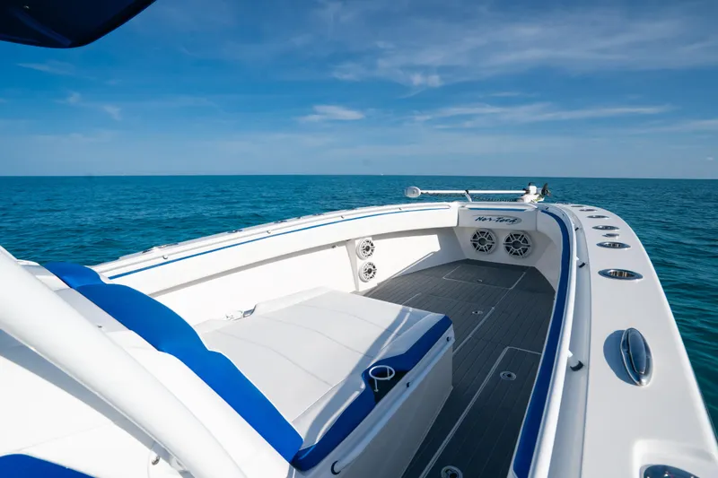 Slide: The Image of 2022 Nor-Tech 392 Super Fish boat on open sea, featuring sleek design and spacious deck. - 14