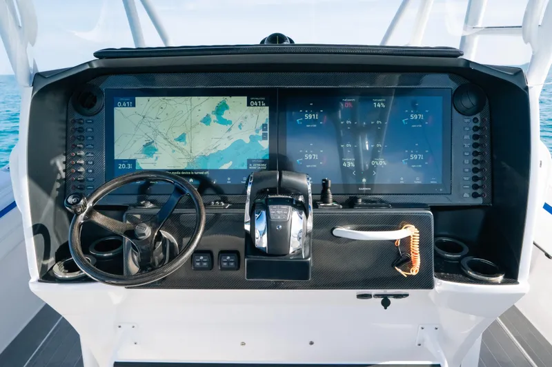 Slide: The Image of Helm of 2022 Nor-Tech 392 Super Fish with advanced navigation displays and controls. - 19