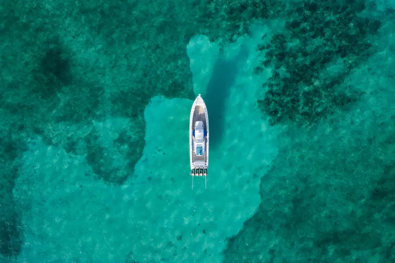 Slide: The Image of Aerial view of 2022 Nor-Tech 392 Super Fish boat on turquoise water. - 45