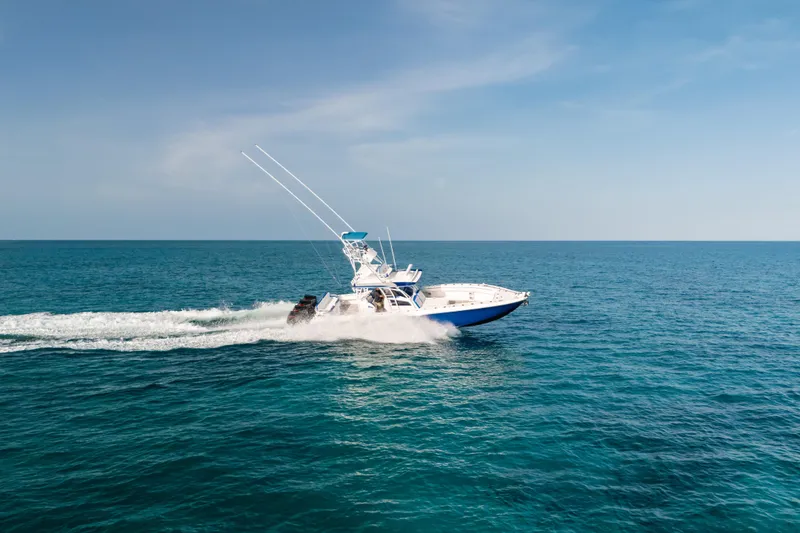 Slide: The Image of 2022 Nor-Tech 392 Super Fish boat cruising on open ocean under clear blue sky. - 48