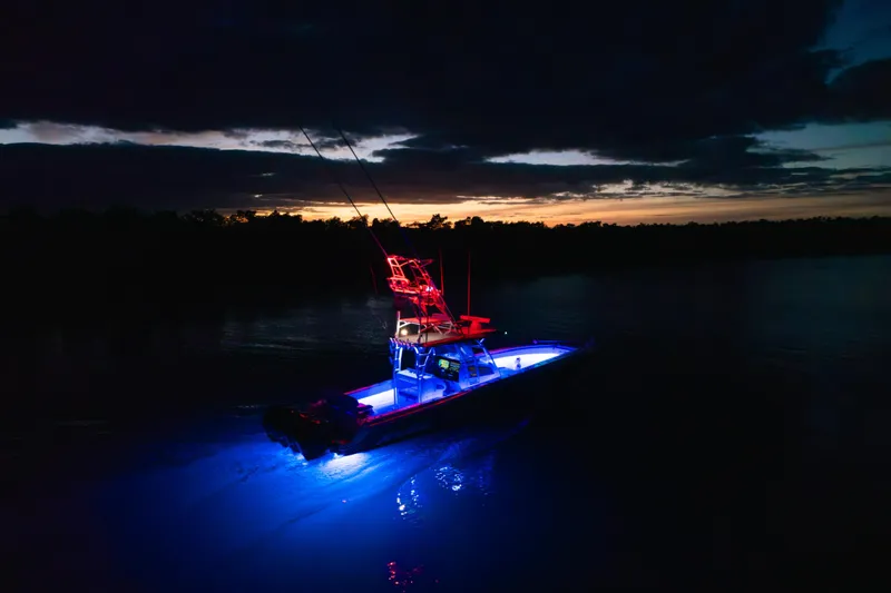 Slide: The Image of 2022 Nor-Tech 392 Super Fish boat illuminated at sunset on calm waters. - 53