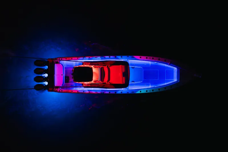 Slide: The Image of Aerial view of 2022 Nor-Tech 392 Super Fish boat with vibrant blue and red lighting. - 55