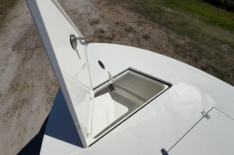 Slide: The Image of Open storage compartment on 2026 Hewes Redfisher 21 boat, showcasing sleek design. - 14