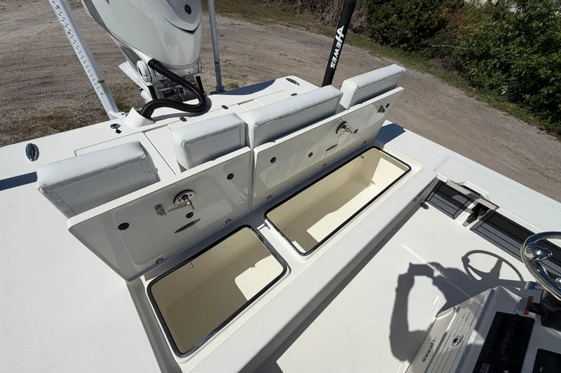 Slide: The Image of 2026 Hewes Redfisher 21 boat with open storage compartments and seating area. - 15