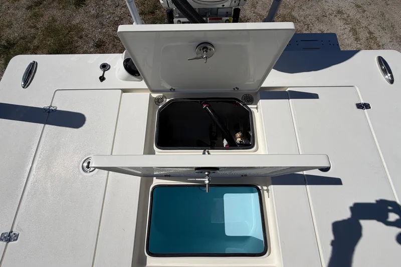 Slide: The Image of 2026 Hewes Redfisher 21 boat deck with open storage compartments. - 17