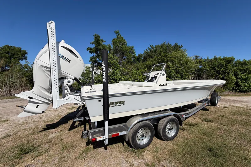 Slide: The Image of 2026 Hewes Redfisher 21 boat on trailer, featuring Yamaha outboard motor, parked outdoors. - 3