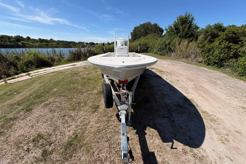 Slide: The Image of 2026 Hewes Redfisher 21 boat on trailer by a scenic lakeside. - 6