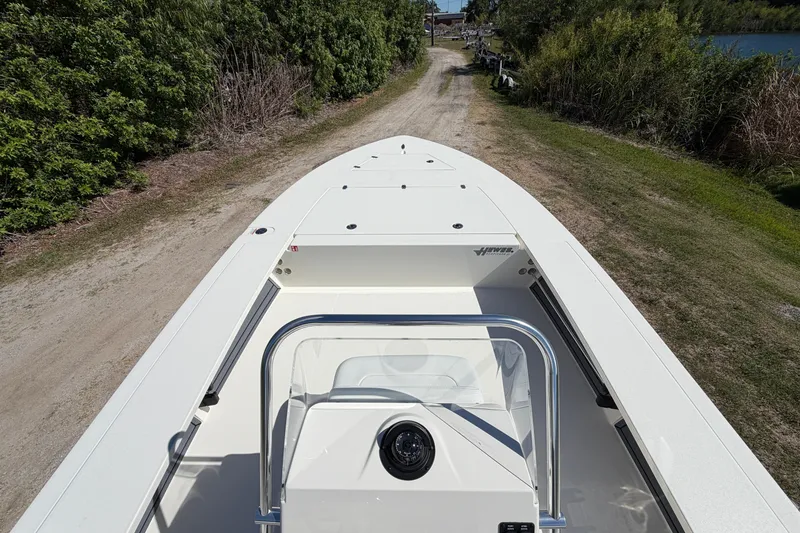 Slide: The Image of 2026 Hewes Redfisher 21 boat on a dirt path, surrounded by greenery. - 9