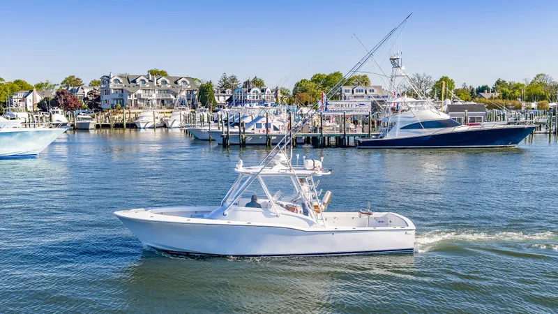 The Image of 2005 L&H Walkaround boat in harbor near docks. - 0