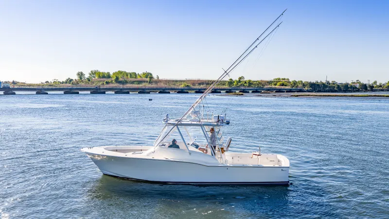 Slide: The Image of 2005 L&H Walkaround boat on calm water. - 12