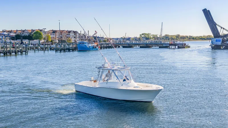 Slide: The Image of 2005 L&H Walkaround boat on calm water near harbor. - 15