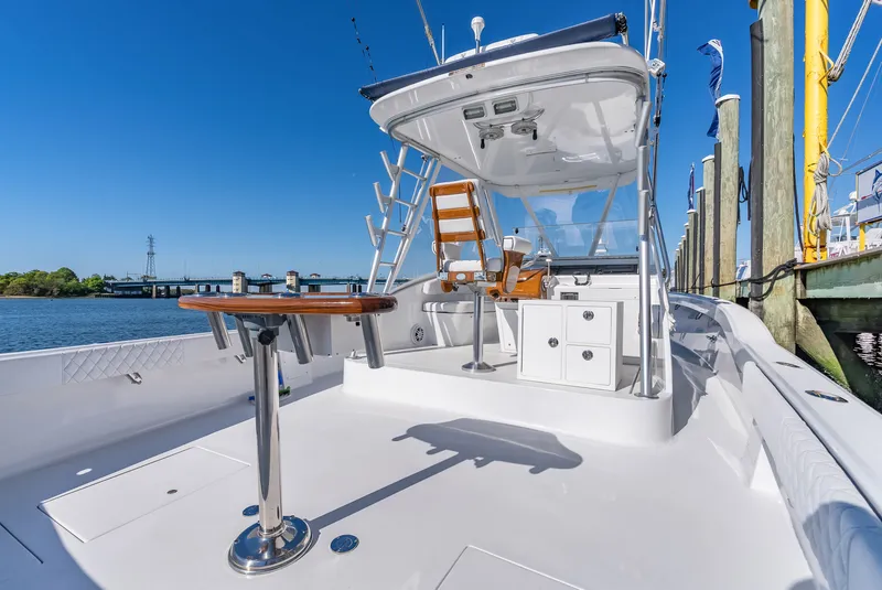 Slide: The Image of 2005 L&H Walkaround boat docked under sunny skies. - 22
