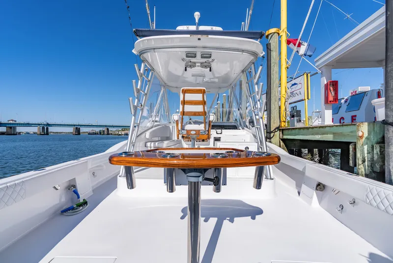 Slide: The Image of 2005 L&H Walkaround boat docked under clear blue sky. - 23