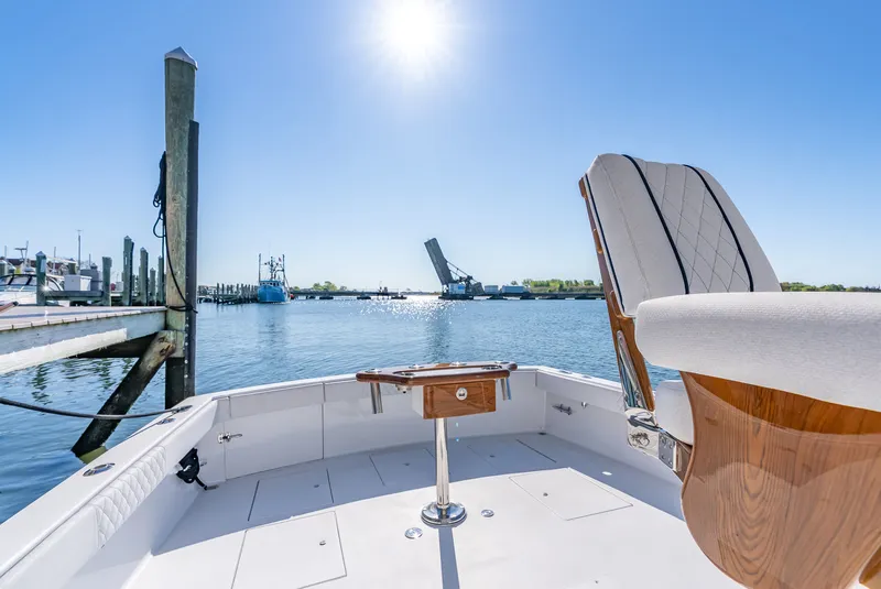 Slide: The Image of 2005 L&H Walkaround boat with open water view and bridge. - 24