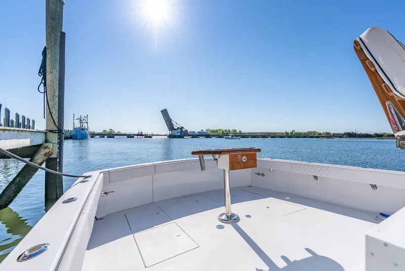 Slide: The Image of 2005 L&H Walkaround boat with bridge in background under sunny sky. - 25