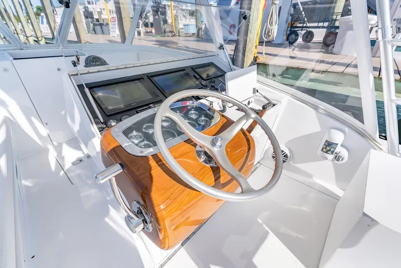 Slide: The Image of Helm of a 2005 L&H Walkaround boat with wooden steering wheel. - 35