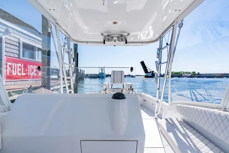 Slide: The Image of Interior view of a 2005 L&H Walkaround boat in harbor. - 36