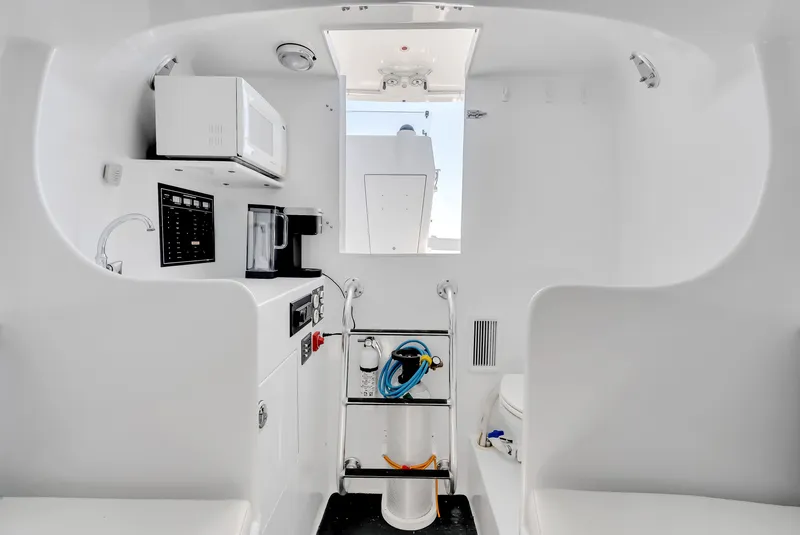 Slide: The Image of Interior of a 2005 L&H Walkaround boat with microwave and ladder. - 42