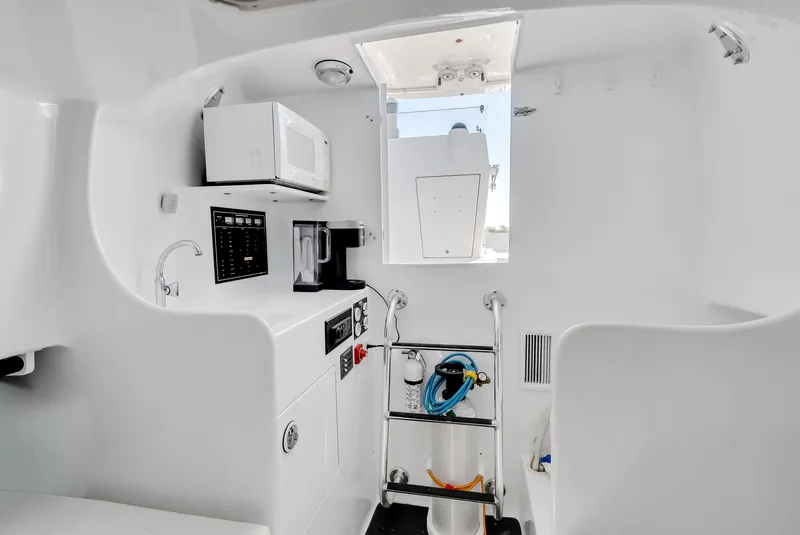 Slide: The Image of Interior of a 2005 L&H Walkaround boat with microwave and ladder. - 43