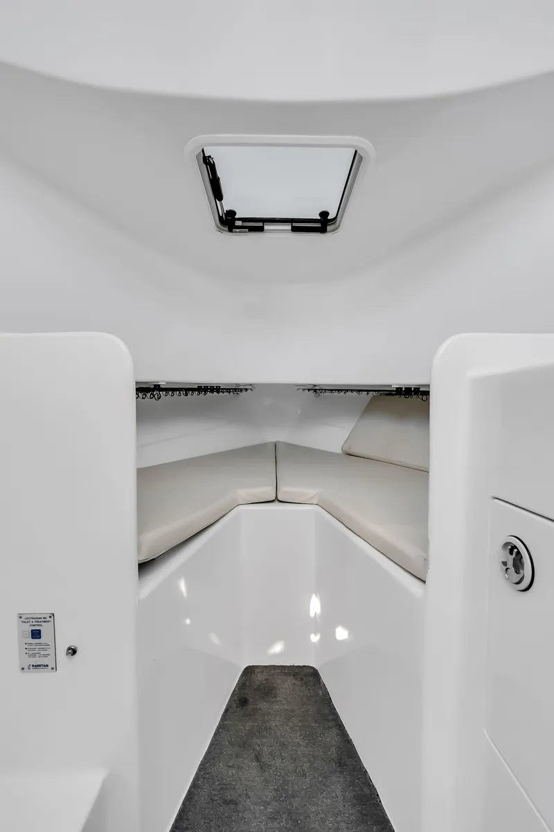 Slide: The Image of Interior of a 2005 L&H Walkaround boat with seating area. - 48
