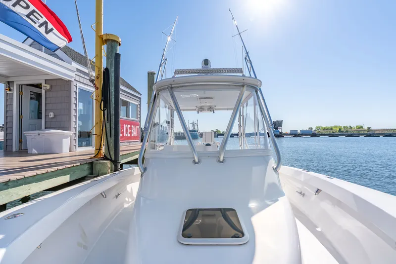 Slide: The Image of 2005 L&H Walkaround boat docked on a sunny day. - 49