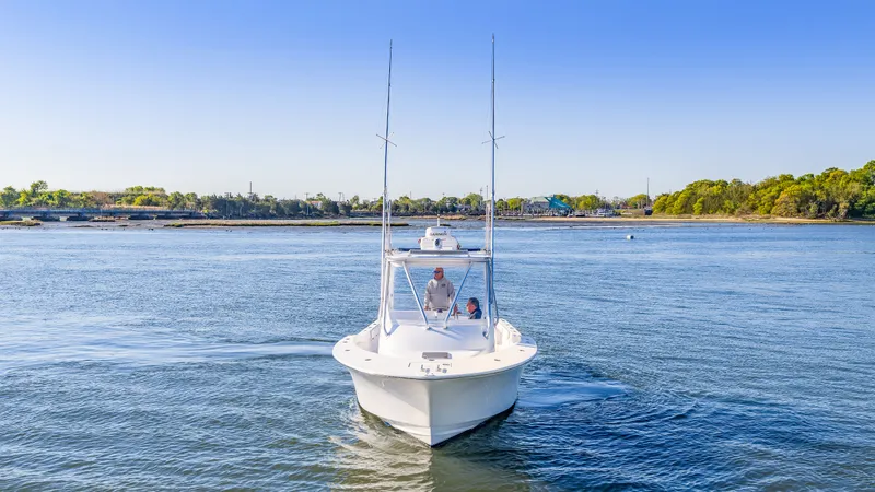 Slide: The Image of 2005 L&H Walkaround boat on calm water under clear sky. - 9