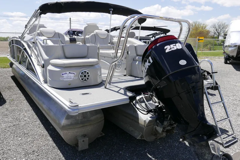 Slide: The Image of 2018 Sylvan S-3 pontoon boat with Suzuki 250 outboard motor, parked on gravel. - 15