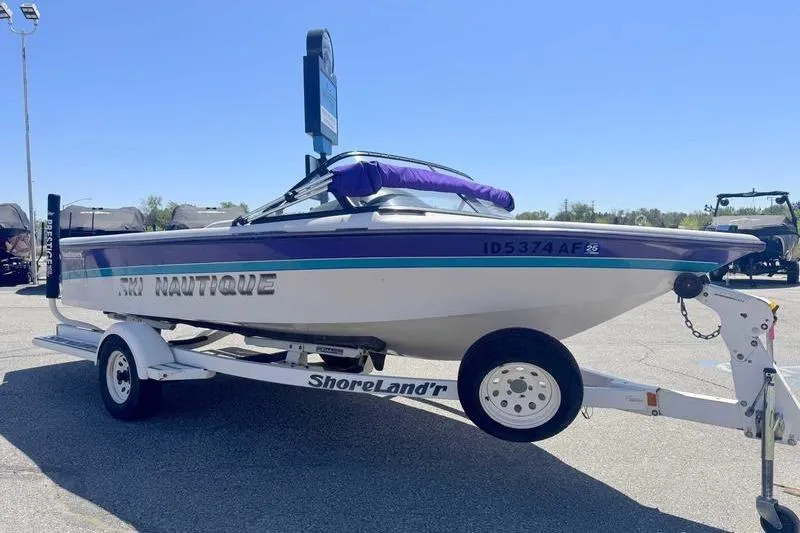 Slide: The Image of 1995 Correct Craft Ski Nautique boat on ShoreLand'r trailer in sunny outdoor setting. - 10
