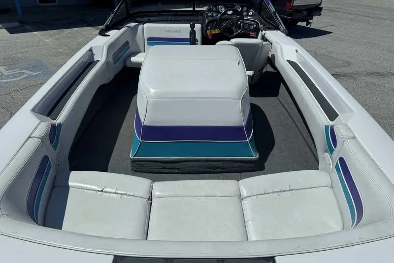 Slide: The Image of 1995 Correct Craft Ski Nautique boat interior with white and teal seating. - 11