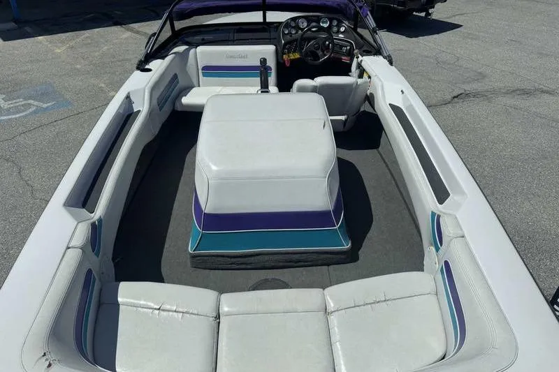 Slide: The Image of 1995 Correct Craft Ski Nautique boat interior with white seating and dashboard. - 13