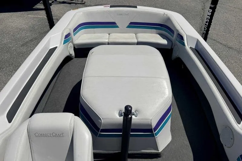 Slide: The Image of 1995 Correct Craft Ski Nautique boat interior with white and blue seating. - 14
