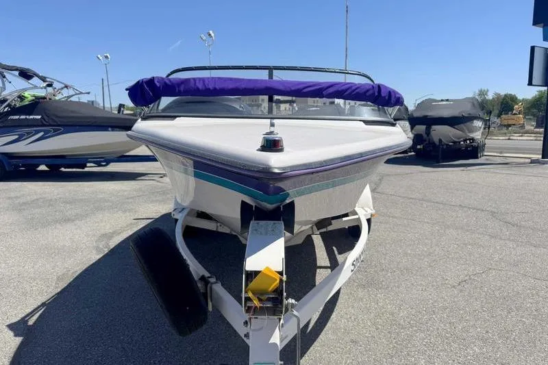 Slide: The Image of 1995 Correct Craft Ski Nautique boat on trailer, parked outdoors under clear blue sky. - 4