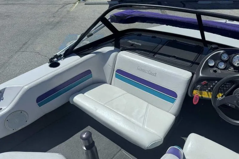 Slide: The Image of 1995 Correct Craft Ski Nautique boat interior with white and blue seating, dashboard, and steering wheel. - 6