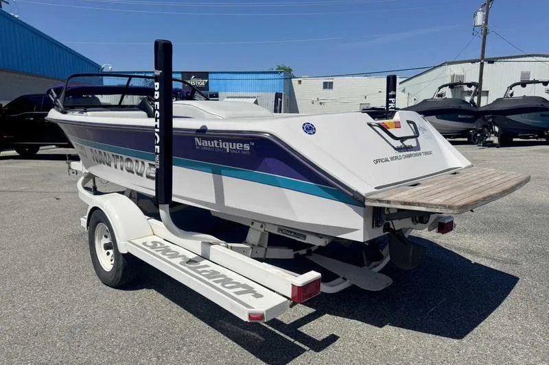 Slide: The Image of 1995 Correct Craft Ski Nautique boat on trailer in outdoor setting. - 9