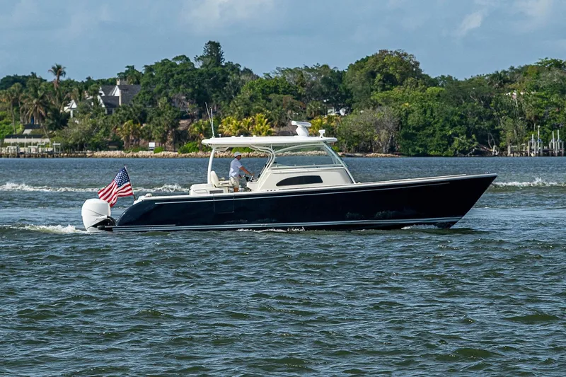 The Image of 2019 Hinckley Sport Boat 40 C cruising on a scenic waterway. - 1
