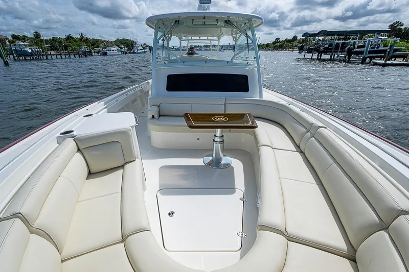 Slide: The Image of 2019 Hinckley Sport Boat 40 C with luxurious seating and table on open water. - 18