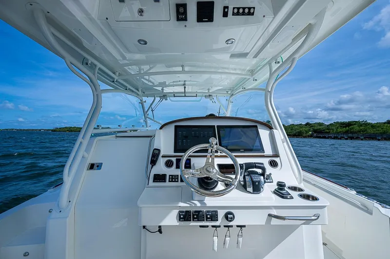 Slide: The Image of Helm of 2019 Hinckley Sport Boat 40 C on open water, clear sky. - 19