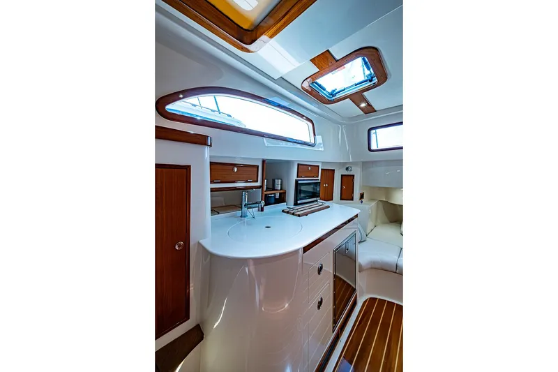 Slide: The Image of Luxurious interior of 2019 Hinckley Sport Boat 40 C with modern kitchen and seating area. - 21