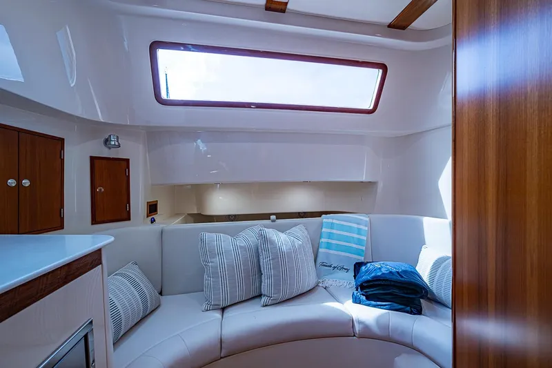 Slide: The Image of Interior of 2019 Hinckley Sport Boat 40 C with cozy seating and cushions. - 22